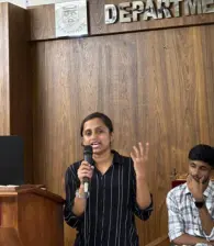 Team member giving a speech at a conference